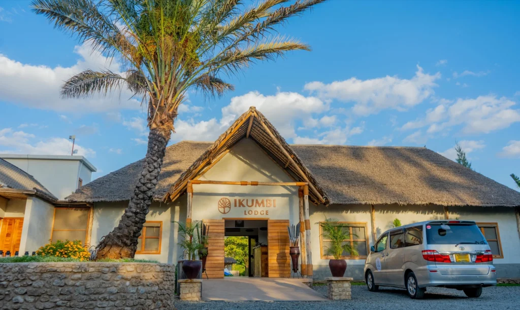 The main entrance gable with the Ikumbi sign and a palm