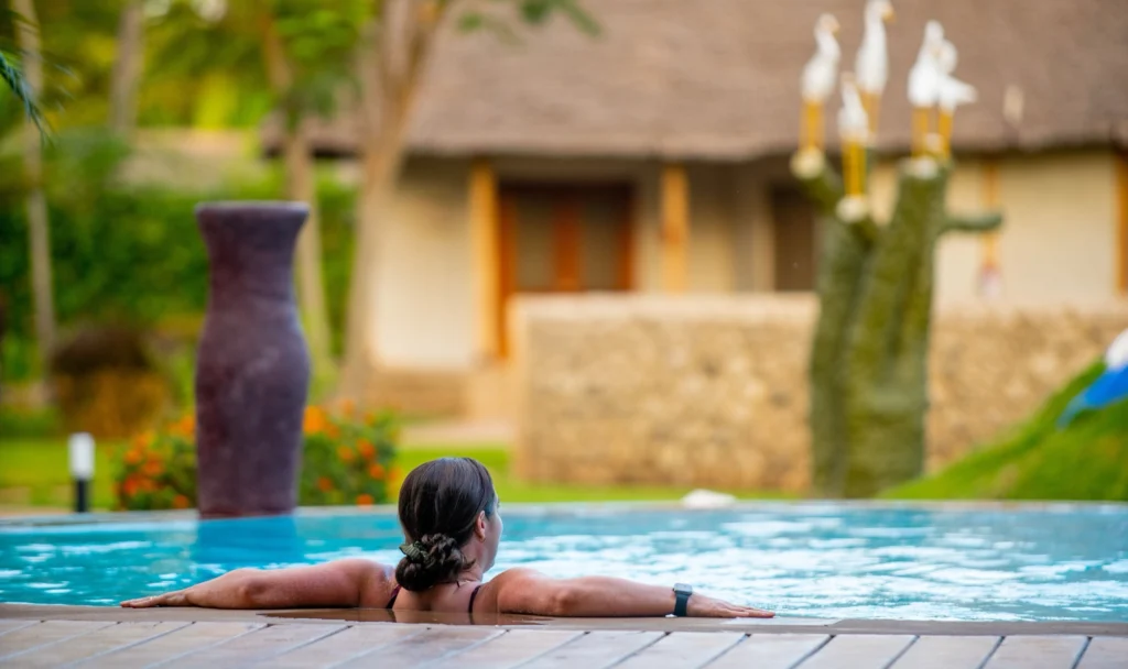 A guest relaxing at the edge of the pool