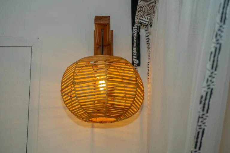 Woven wall lamp beside the mosquito net